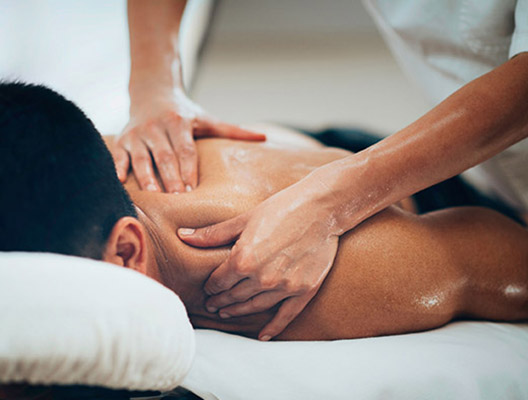 53980764 - physical therapist doing massage of male's shoulder