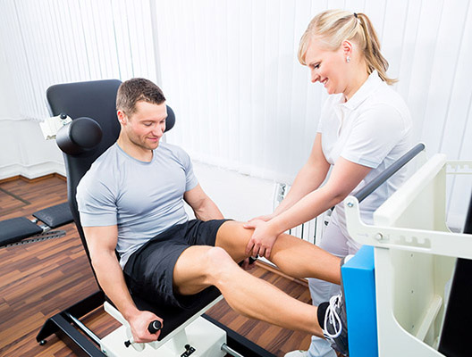 Patient at the physiotherapy doing physical exercises using leg press in sport remobilization