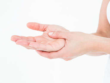 Woman with hand pain on white background