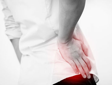 Young man in casual office shirt having hip pain