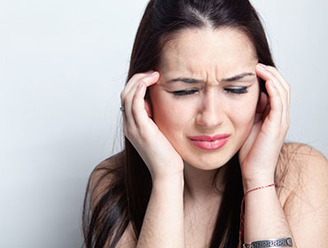 12552666 - headache concept - young woman suffering a migraine