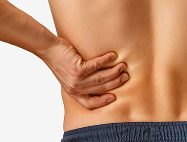 Man touches the lower back, pain in the kidney. On a white background